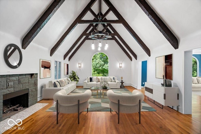 6470 Around The Hills Rd, Indianapolis, IN 46226 - living room featuring healthy amount of natural light, wood finished floors, beamed ceiling, high vaulted ceiling, and a stone fireplace