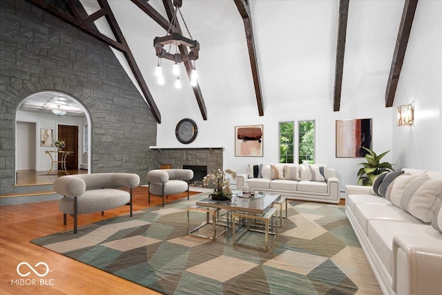 6470 Around The Hills Rd, Indianapolis, IN 46226 - living area with a fireplace, high vaulted ceiling, arched walkways, beam ceiling, and a chandelier