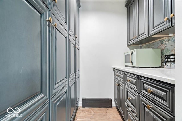6470 Around The Hills Rd, Indianapolis, IN 46226 - laundry room with baseboards and light tile patterned floors