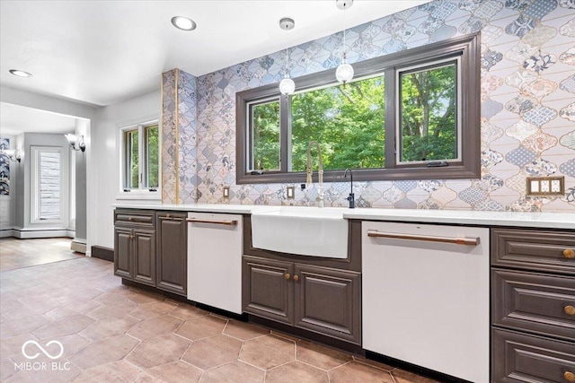 6470 Around The Hills Rd, Indianapolis, IN 46226 - kitchen with white dishwasher, light countertops, dark brown cabinets, wallpapered walls, and recessed lighting