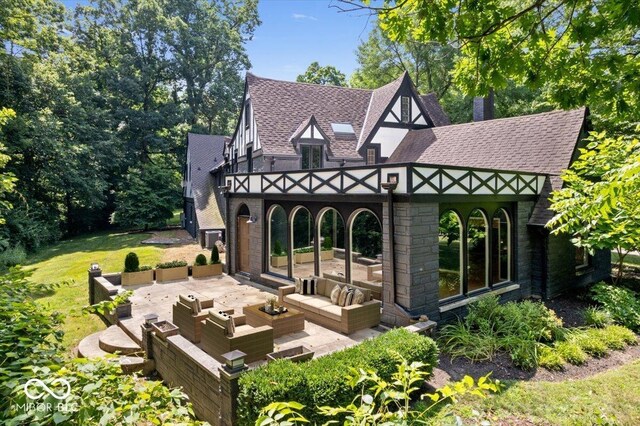 6470 Around The Hills Rd, Indianapolis, IN 46226 - rear view of property featuring an outdoor hangout area, a shingled roof, a patio area, and a lawn
