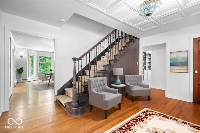 6470 Around The Hills Rd, Indianapolis, IN 46226 - entrance foyer with stairs, wood finished floors, baseboard heating, and a chandelier