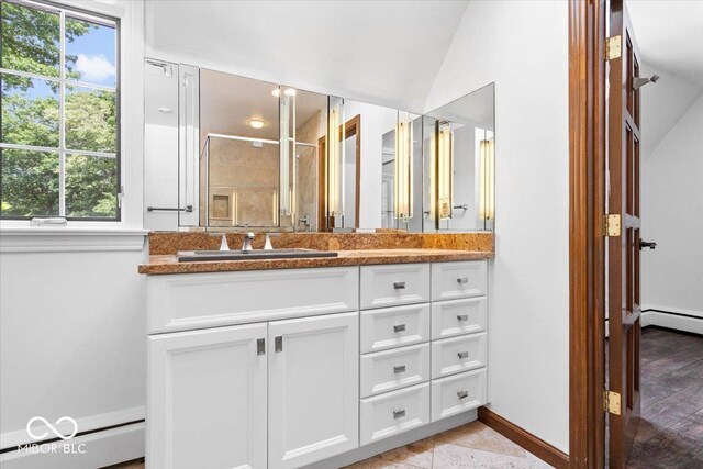 6470 Around The Hills Rd, Indianapolis, IN 46226 - bathroom with baseboard heating, vanity, vaulted ceiling, and a shower with shower door