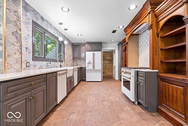 6470 Around The Hills Rd, Indianapolis, IN 46226 - kitchen with white appliances, backsplash, light countertops, recessed lighting, and wallpapered walls