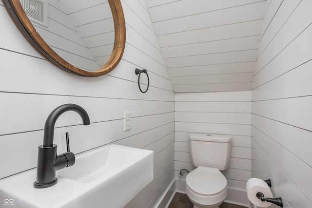 1456 Fletcher Ave, Indianapolis, IN 46203 - half bathroom featuring wood walls and wood finished floors
