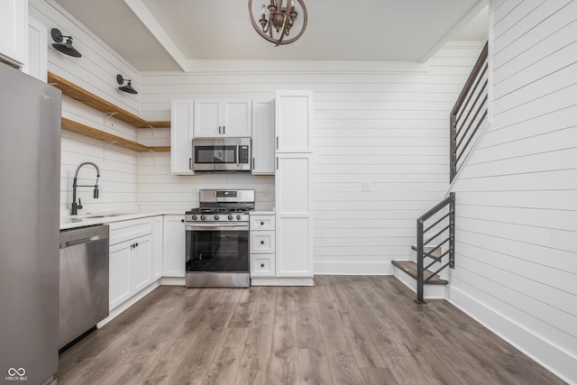 1456 Fletcher Ave, Indianapolis, IN 46203 - kitchen featuring appliances with stainless steel finishes, open shelves, light countertops, white cabinets, and decorative backsplash