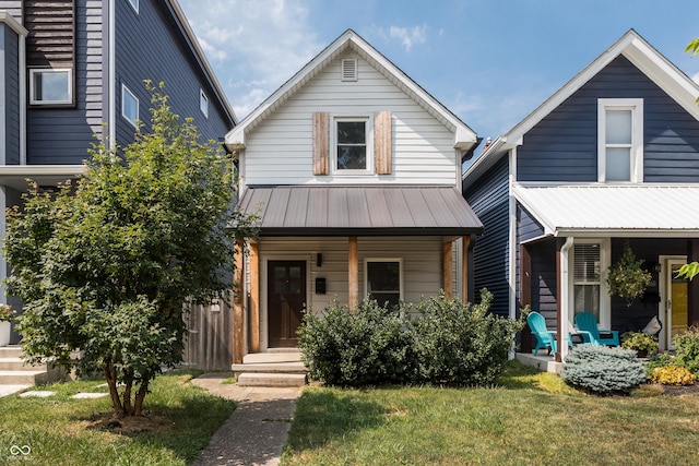 1456 Fletcher Ave, Indianapolis, IN 46203 - view of front of home with covered porch, a metal roof, and a front lawn