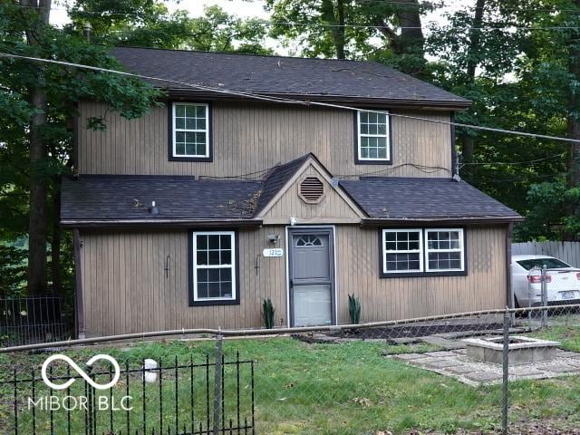 view of front facade with roof with shingles