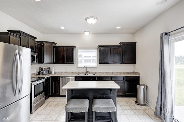 1270 W Limestone Way, Fortville, IN 46040 - kitchen featuring stainless steel appliances, light countertops, a breakfast bar area, dark brown cabinets, and recessed lighting