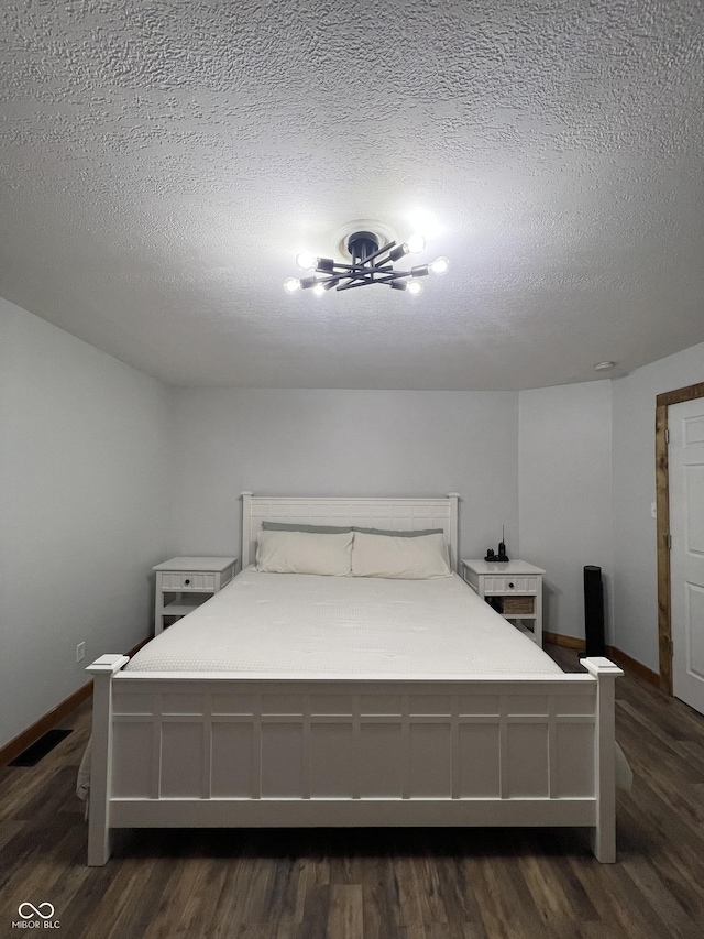 1203 S 6th St, Clinton, IN 47842 - bedroom featuring a textured ceiling and dark wood-style flooring