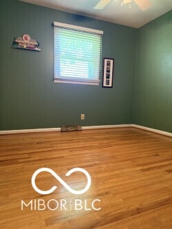 4680 Cartersburg Rd, Plainfield, IN 46168 - unfurnished room with wood finished floors and ceiling fan