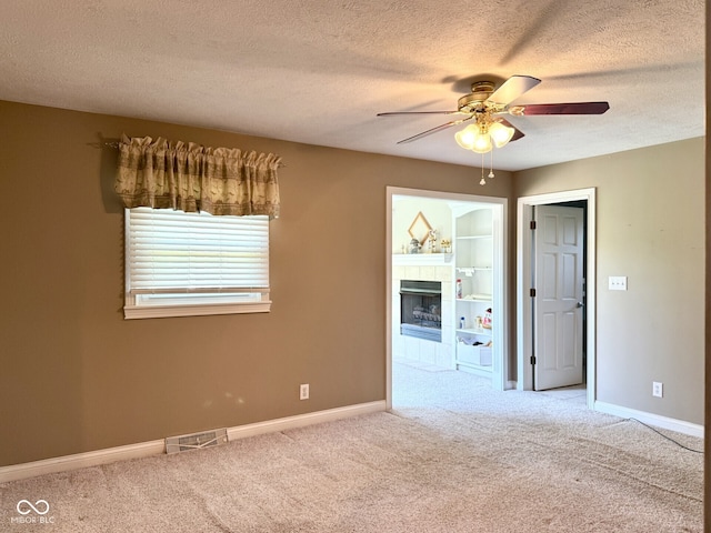 4680 Cartersburg Rd, Plainfield, IN 46168 - carpeted empty room featuring ceiling fan, a textured ceiling, and a fireplace