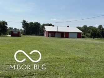 4680 Cartersburg Rd, Plainfield, IN 46168 - view of green lawn featuring a garage, an outbuilding, and driveway