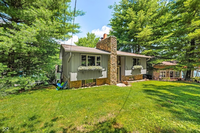 6254 Grosbeak Ct, Nineveh, IN 46164 - view of front facade featuring a chimney, a front yard, and board and batten siding