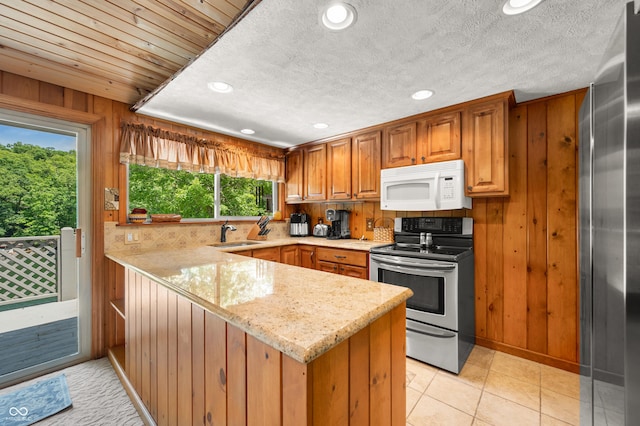 6254 Grosbeak Ct, Nineveh, IN 46164 - kitchen with appliances with stainless steel finishes, a peninsula, recessed lighting, light stone countertops, and wooden walls