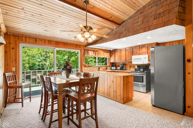 6254 Grosbeak Ct, Nineveh, IN 46164 - dining area with wood ceiling, lofted ceiling, wood walls, a ceiling fan, and light tile patterned floors