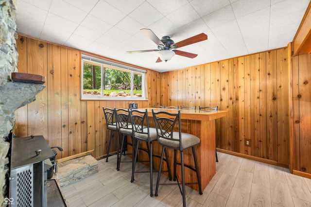 6254 Grosbeak Ct, Nineveh, IN 46164 - indoor dry bar with a ceiling fan, light wood-style floors, and wood walls