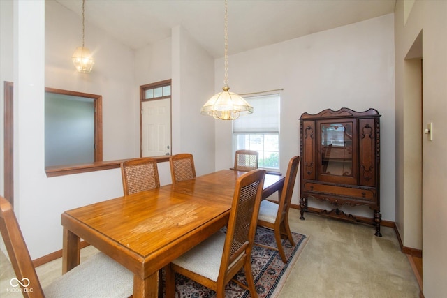 4625 Pine Park Ln, Indianapolis, IN 46268 - dining space with light colored carpet, vaulted ceiling, and a chandelier