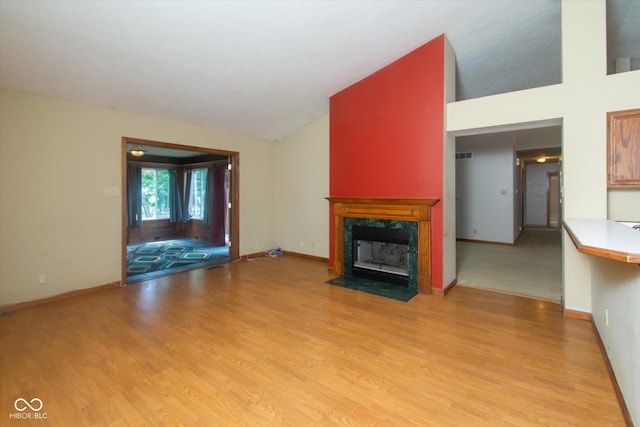 4625 Pine Park Ln, Indianapolis, IN 46268 - unfurnished living room featuring vaulted ceiling, a fireplace, and light wood-style flooring
