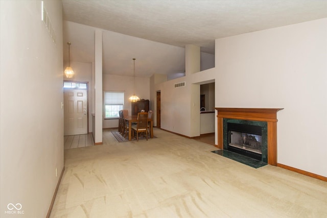 4625 Pine Park Ln, Indianapolis, IN 46268 - carpeted living area featuring high vaulted ceiling, a chandelier, and a fireplace