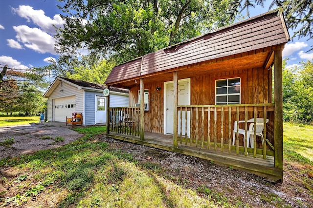 5508 S State Rd 59, Clay City, IN 47841 - view of front of home with an outbuilding, a detached garage, and roof with shingles