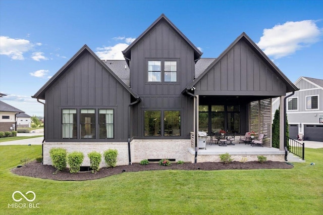 20440 Chatham Hills Blvd, Westfield, IN 46074 - rear view of house featuring board and batten siding, a lawn, and a patio