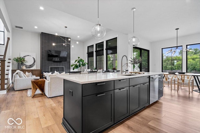 20440 Chatham Hills Blvd, Westfield, IN 46074 - kitchen featuring stainless steel dishwasher, light countertops, a kitchen island with sink, healthy amount of natural light, and recessed lighting