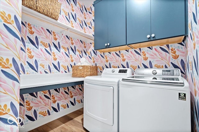 20440 Chatham Hills Blvd, Westfield, IN 46074 - laundry area featuring cabinet space, wallpapered walls, washing machine and dryer, and wood finished floors