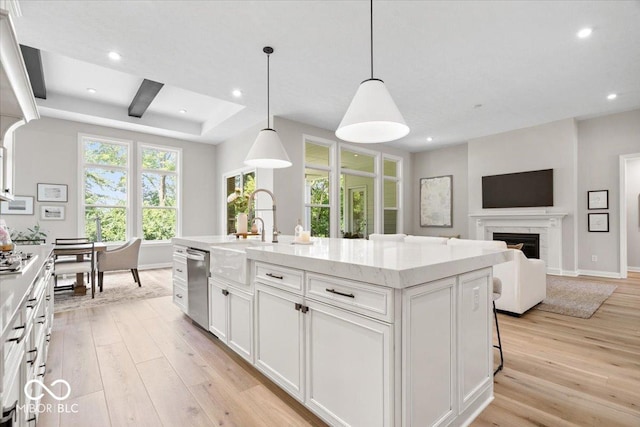 2840 Flowing Creek Pl, Westfield, IN 46074 - kitchen with appliances with stainless steel finishes, light wood-style floors, white cabinets, recessed lighting, and a center island with sink