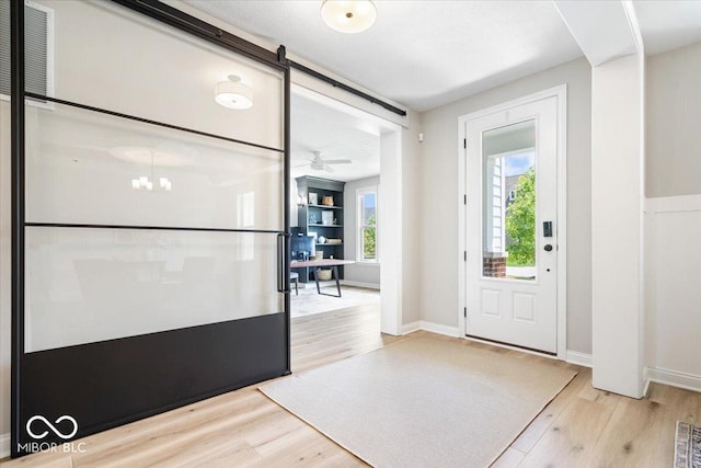 2840 Flowing Creek Pl, Westfield, IN 46074 - entryway featuring wood finished floors, a barn door, and a chandelier