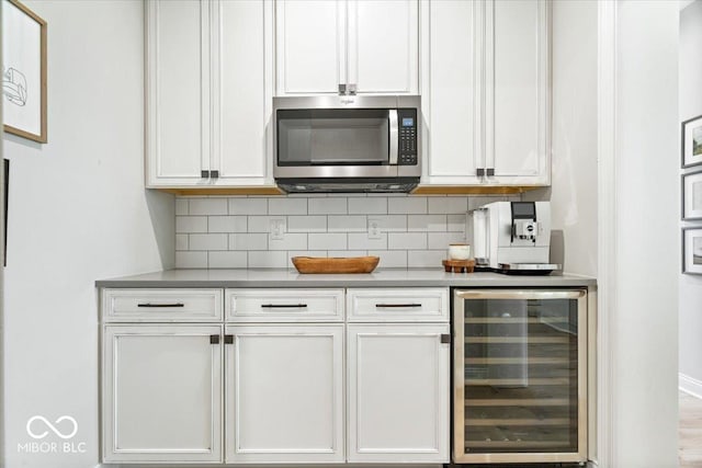 2840 Flowing Creek Pl, Westfield, IN 46074 - bar area featuring stainless steel microwave, wine cooler, and decorative backsplash