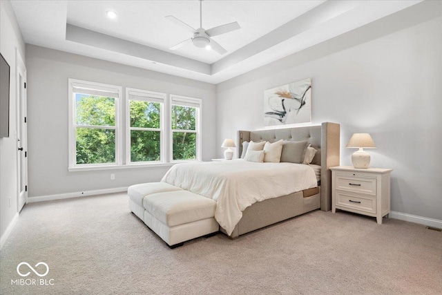2840 Flowing Creek Pl, Westfield, IN 46074 - bedroom with light colored carpet, a tray ceiling, and ceiling fan