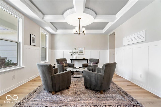 2840 Flowing Creek Pl, Westfield, IN 46074 - living area featuring coffered ceiling, a chandelier, ornamental molding, healthy amount of natural light, and light wood finished floors