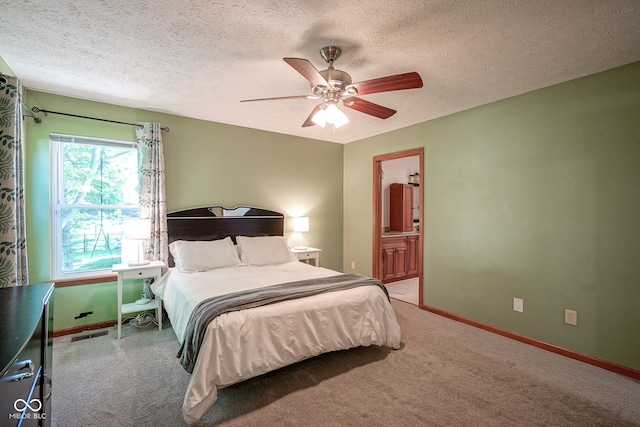 1804 Emerald Pines Ln, Westfield, IN 46074 - bedroom featuring a textured ceiling, light colored carpet, a ceiling fan, and ensuite bathroom