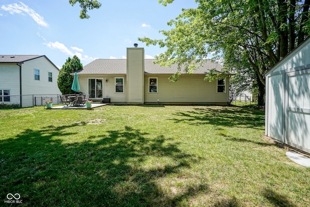 1804 Emerald Pines Ln, Westfield, IN 46074 - back of house featuring a chimney, a patio area, and an outdoor structure