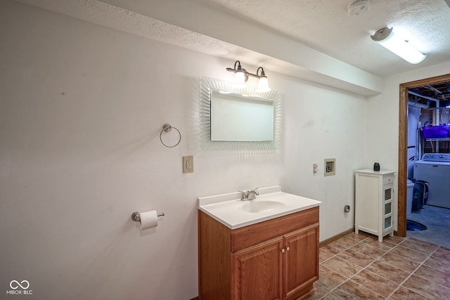 1804 Emerald Pines Ln, Westfield, IN 46074 - bathroom featuring washer / clothes dryer, vanity, and a textured ceiling