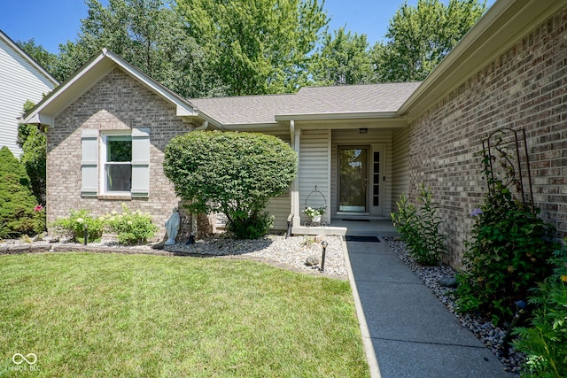 1804 Emerald Pines Ln, Westfield, IN 46074 - view of exterior entry featuring brick siding, a lawn, and roof with shingles