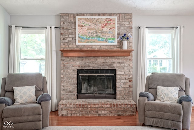 1804 Emerald Pines Ln, Westfield, IN 46074 - living room with wood finished floors, a textured ceiling, and a fireplace