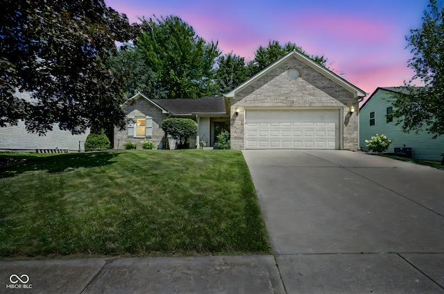 1804 Emerald Pines Ln, Westfield, IN 46074 - ranch-style home with concrete driveway, a garage, a front yard, brick siding, and stone siding