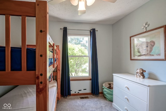 1804 Emerald Pines Ln, Westfield, IN 46074 - bedroom featuring multiple windows, light colored carpet, a textured ceiling, and a ceiling fan