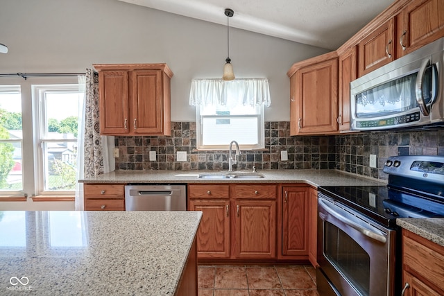 1804 Emerald Pines Ln, Westfield, IN 46074 - kitchen featuring appliances with stainless steel finishes, vaulted ceiling, decorative backsplash, and plenty of natural light