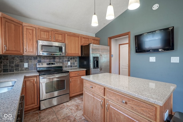 1804 Emerald Pines Ln, Westfield, IN 46074 - kitchen featuring stainless steel appliances, decorative backsplash, vaulted ceiling, and light stone counters
