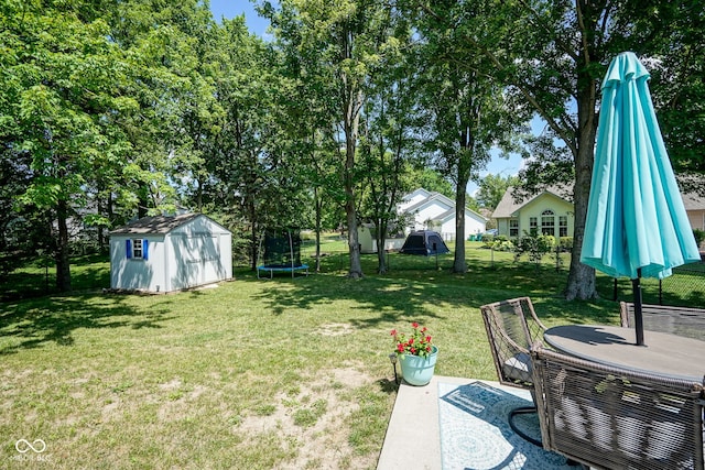 1804 Emerald Pines Ln, Westfield, IN 46074 - view of grassy yard with a storage shed, a trampoline, and a patio