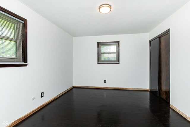 1202 E Stop 10th Rd, Indianapolis, IN 46227 - spare room with baseboards and dark wood finished floors
