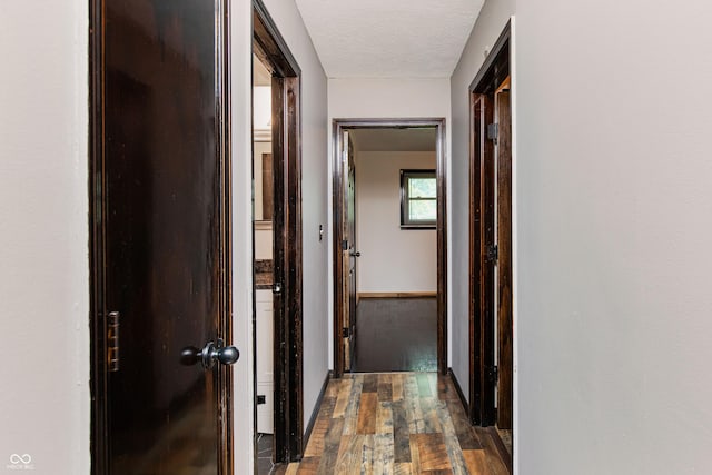 1202 E Stop 10th Rd, Indianapolis, IN 46227 - corridor featuring dark wood-style floors and a textured ceiling