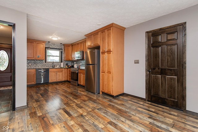 1202 E Stop 10th Rd, Indianapolis, IN 46227 - kitchen with appliances with stainless steel finishes, dark wood-style flooring, backsplash, dark countertops, and brown cabinetry