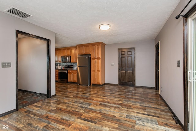 1202 E Stop 10th Rd, Indianapolis, IN 46227 - kitchen featuring stainless steel appliances, dark wood-style floors, decorative backsplash, brown cabinets, and a textured ceiling