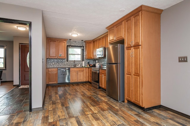 1202 E Stop 10th Rd, Indianapolis, IN 46227 - kitchen with stainless steel appliances, tasteful backsplash, dark countertops, and dark wood-style floors