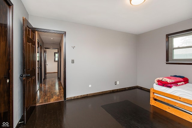 1202 E Stop 10th Rd, Indianapolis, IN 46227 - unfurnished bedroom with wood finished floors and baseboards