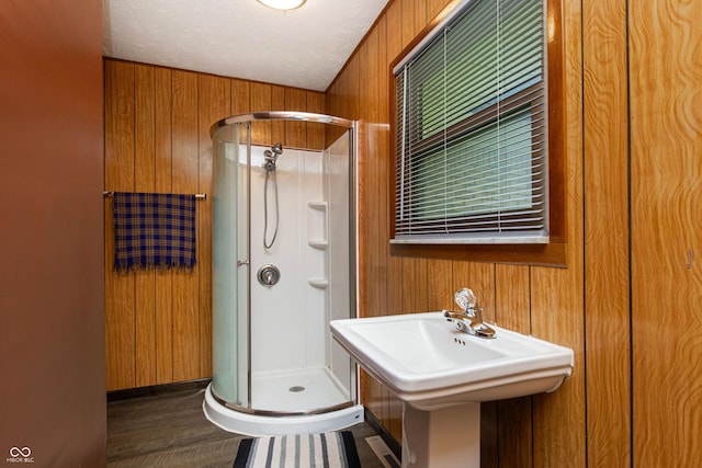 1202 E Stop 10th Rd, Indianapolis, IN 46227 - full bathroom with a stall shower, wooden walls, wood finished floors, and a textured ceiling